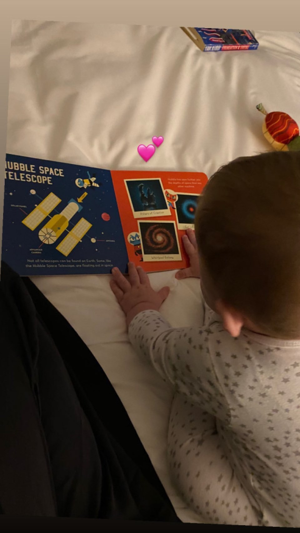 Grimes and Elon Musk's son X AE A-Xii playing with space book 